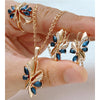 Rose gold jewelry set featuring blue marquise-cut crystals with matching pendant necklace, earrings, and statement ring in a leaf-inspired design.