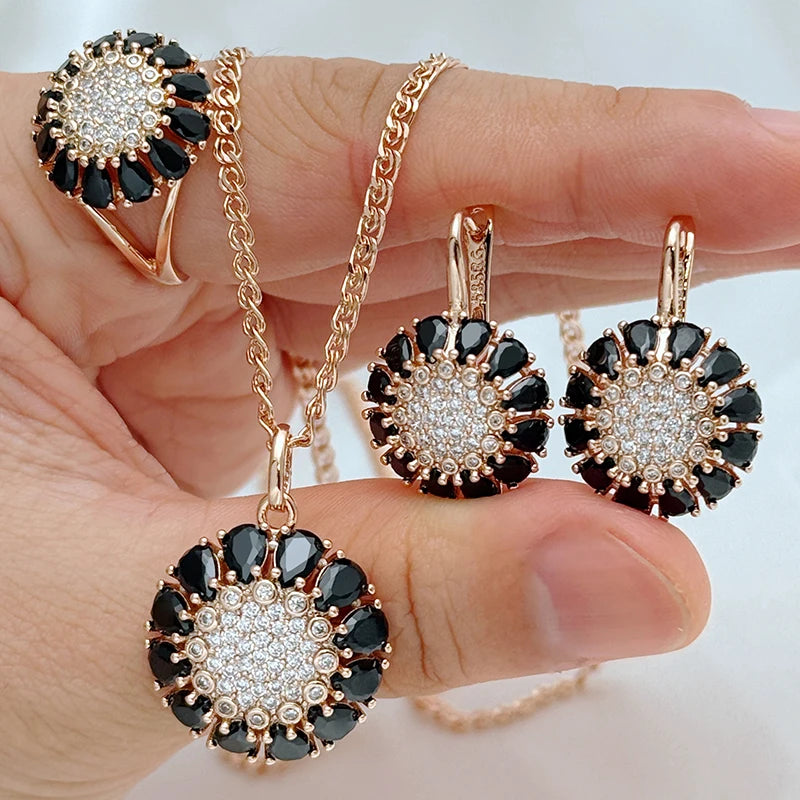 Luxury black crystal sunburst jewelry set featuring matching necklace, earrings, and ring in rose gold finish for women